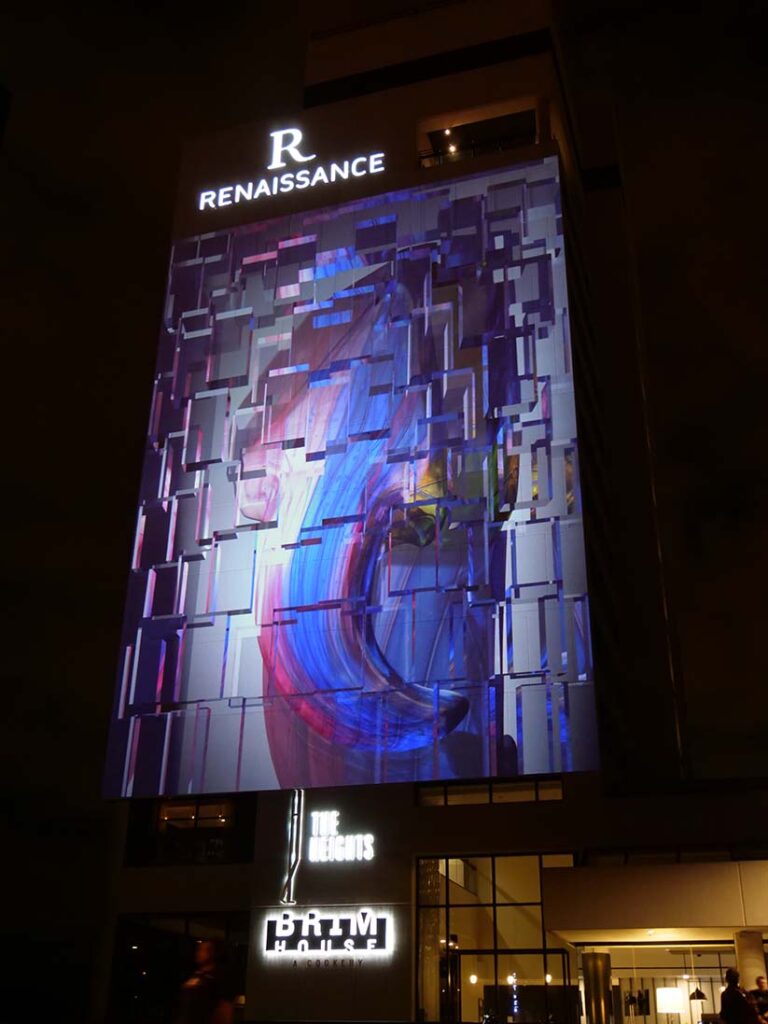 Facade of Renaissance Hotel in Toledo with video mapping projection of glass arrow on the surface