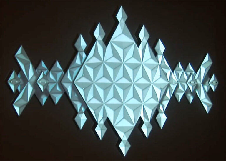 Portal sculpture showing a frame with 3d looking triangles in a grid-like pattern