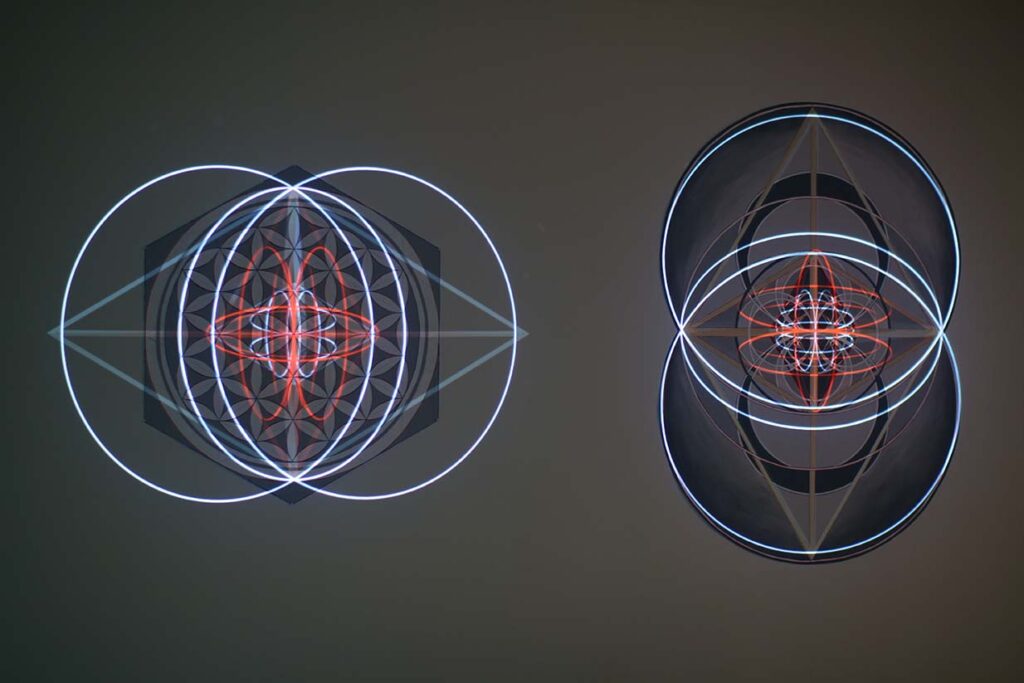 Flower of Life and Vesica Piscis paintings side by side with projection on them