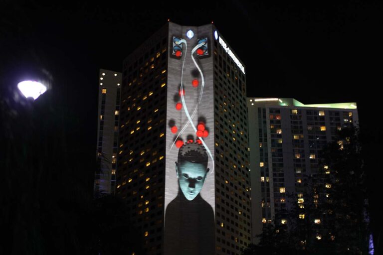 Projection of a person's head with little balls bouncing around.